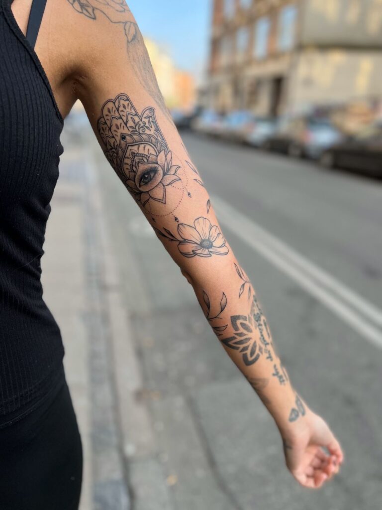 feminine beautiful tattoo sleeve with hamsa hand, butterflies and pattern